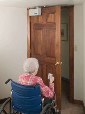 older woman opening door in wheelchair