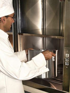 chef placing food in dumbwaiter